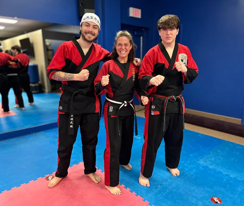 Certified karate instructors smiling together at Murray's Martial Arts dojo.
