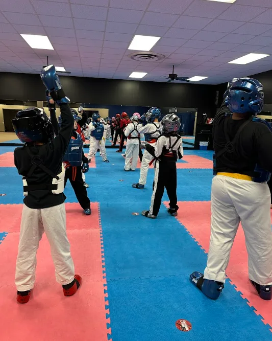 Children wearing protective gear during safe karate training drills in Greece, NY.